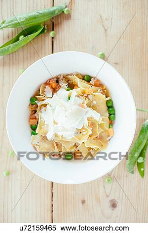 "Plate of fresh pasta with carrots, peas and grated cheese" View Large Photo Image Stock Photography - "Plate of fresh pasta with carrots, peas and grated cheese". Fotosearch
