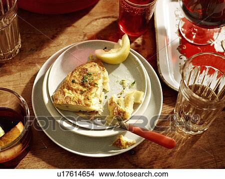 Picture - Plate with spanish omelette and lemon. Fotosearch
