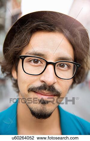 Portrait of bespectacled young man with hat View Large Photo Image Stock Image - Portrait of bespectacled young man with hat. Fotosearch