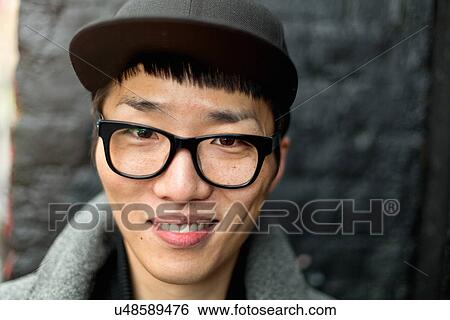 Portrait of bespectacled young man with cap View Large Photo Image Stock Photograph - Portrait of bespectacled young man with cap. Fotosearch