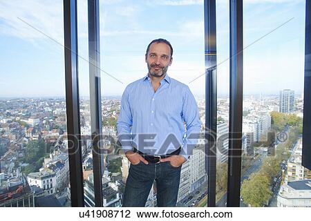 "Portrait of businessman in front of office window with Brussels cityscape, Belgium" View Large Photo Image Stock Image - "Portrait of businessman in front of office window with Brussels cityscape, Belgium". Fotosearch