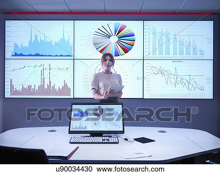 Portrait of businesswoman making presentation in front of graphs on screen View Large Photo Image Stock Image - Portrait of businesswoman making presentation in front of graphs on screen. Fotosearch