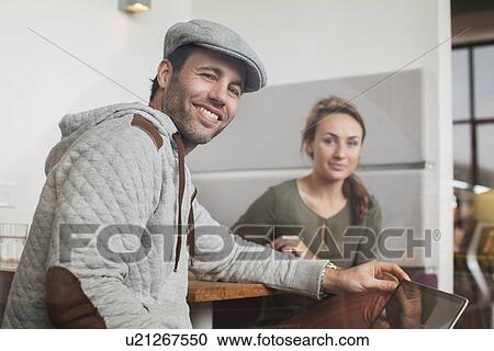 Stock Image - Portrait of colleagues in office meeting. Fotosearch