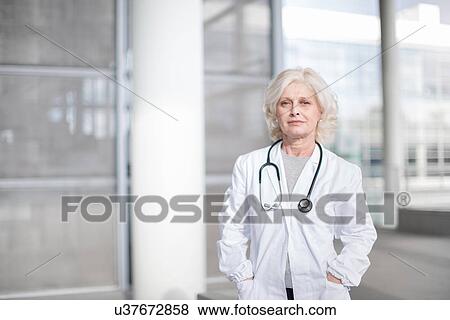 "Portrait of female doctor, standing outside building" View Large Photo Image Stock Photo - "Portrait of female doctor, standing outside building". Fotosearch