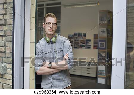 Picture - Portrait of male designer in office doorway. Fotosearch