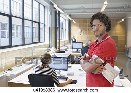 Portrait of man in busy creative office View Large Photo Image Stock Photograph - Portrait of man in busy creative office. Fotosearch