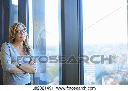 Stock Image - "Portrait of mature businesswoman in skyscraper office, Brussels, Belgium". Fotosearch