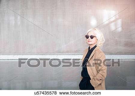 Stock Photo - "Portrait of mature businesswoman, wearing sunglasses". Fotosearch
