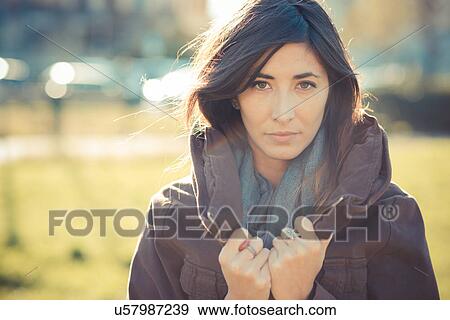 Portrait of mid adult woman holding collar in park View Large Photo Image Stock Photo - Portrait of mid adult woman holding collar in park. Fotosearch