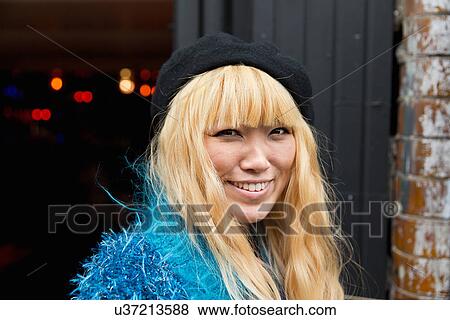 Stock Photo - Portrait of mid adult woman in blue furry top. Fotosearch