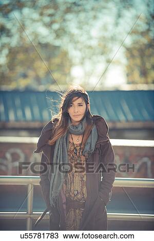 Portrait of mid adult woman standing on roadside View Large Photo Image Stock Image - Portrait of mid adult woman standing on roadside. Fotosearch