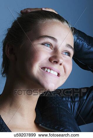 Portrait of pretty teenage girl with hand on her head View Large Photo Image Stock Photo - Portrait of pretty teenage girl with hand on her head. Fotosearch