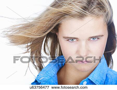 Stock Photo - Portrait of pretty teenage girl with hair blowing. Fotosearch