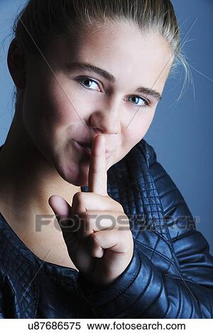 Portrait of pretty teenage girl with finger on her lips View Large Photo Image Stock Photography - Portrait of pretty teenage girl with finger on her lips. Fotosearch