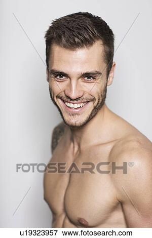 Portrait of smiling bare chested young man View Large Photo Image Stock Photo - Portrait of smiling bare chested young man. Fotosearch