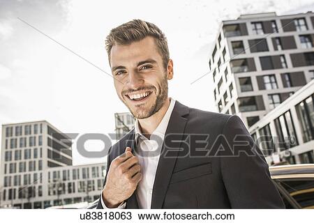Portrait of smiling young businessman on street View Large Photo Image Stock Image - Portrait of smiling young businessman on street. Fotosearch