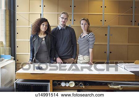 Portrait of three young designers in creative office View Large Photo Image Picture - Portrait of three young designers in creative office. Fotosearch