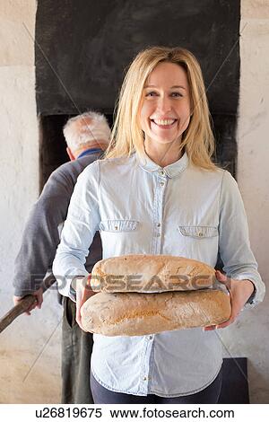 Portrait of woman holding Tuscan breads View Large Photo Image Stock Photography - Portrait of woman holding Tuscan breads. Fotosearch