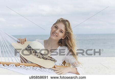 "Portrait of young blond woman with sunhat on Miami Beach, Florida, USA" View Large Photo Image Stock Image - "Portrait of young blond woman with sunhat on Miami Beach, Florida, USA". Fotosearch