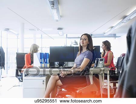 Portrait of young businesswoman at office desk View Large Photo Image Stock Image - Portrait of young businesswoman at office desk. Fotosearch