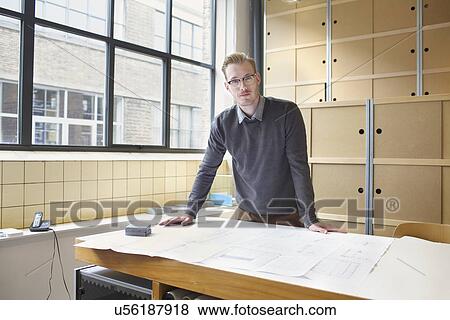 Portrait of young male designer in creative office View Large Photo Image Stock Photo - Portrait of young male designer in creative office. Fotosearch