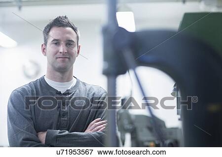 Portrait of young male technician in workshop View Large Photo Image Stock Photo - Portrait of young male technician in workshop. Fotosearch