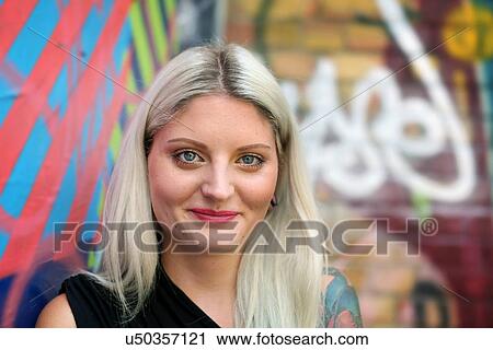 "Portrait of young woman, graffiti in background" View Large Photo Image Stock Image - "Portrait of young woman, graffiti in background". Fotosearch