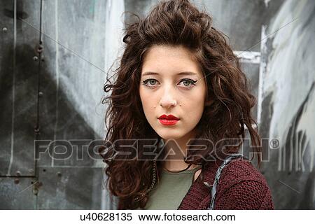 Stock Photography - "Portrait of young woman, graffiti in background". Fotosearch