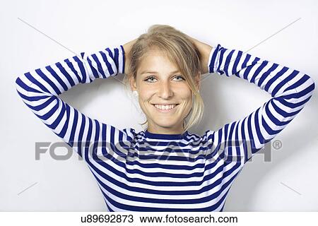 Stock Image - "Portrait of young woman, hands behind head". Fotosearch