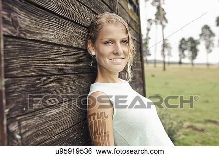 "Portrait of young woman, leaning against wooden cart" View Large Photo Image Stock Photograph - "Portrait of young woman, leaning against wooden cart". Fotosearch