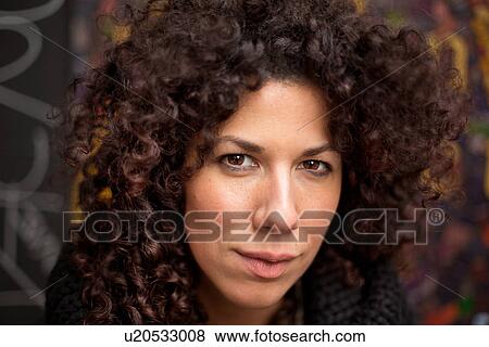 Portrait of young woman with curly hair View Large Photo Image Stock Photo - Portrait of young woman with curly hair. Fotosearch
