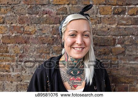 Portrait of young woman with nose ring stud and tattoo View Large Photo Image Stock Photograph - Portrait of young woman with nose ring stud and tattoo. Fotosearch
