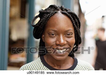 Portrait of young woman with plaited hairstyle View Large Photo Image Stock Photography - Portrait of young woman with plaited hairstyle. Fotosearch