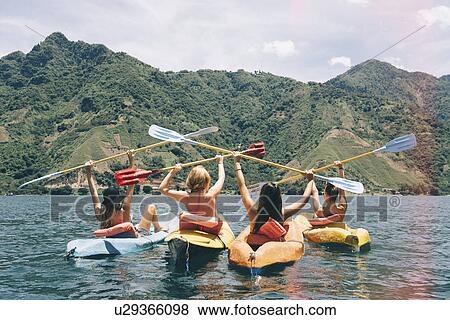 "Rear view of four female friends celebrating in kayaks on Lake Atitlan, Guatemala" View Large Photo Image Stock Photo - "Rear view of four female friends celebrating in kayaks on Lake Atitlan, Guatemala". Fotosearch