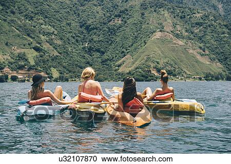 "Rear view of four young female friends kayaking on Lake Atitlan, Guatemala" View Large Photo Image Stock Image - "Rear view of four young female friends kayaking on Lake Atitlan, Guatemala". Fotosearch