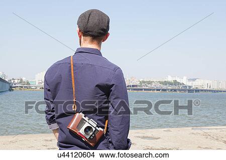 "Rear view of male tourist looking at view of river, Seoul, South Korea" View Large Photo Image Picture - "Rear view of male tourist looking at view of river, Seoul, South Korea". Fotosearch