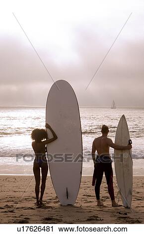 "Rear view of young surfing couple looking out to sea, Playa Del Rey, California, USA" View Large Photo Image Stock Image - "Rear view of young surfing couple looking out to sea, Playa Del Rey, California, USA". Fotosearch
