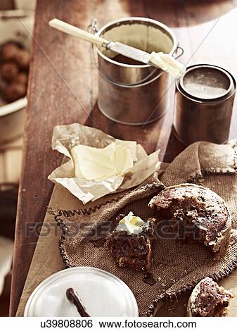 Stock Photograph - Rustic table with billycan bun and butter. Fotosearch