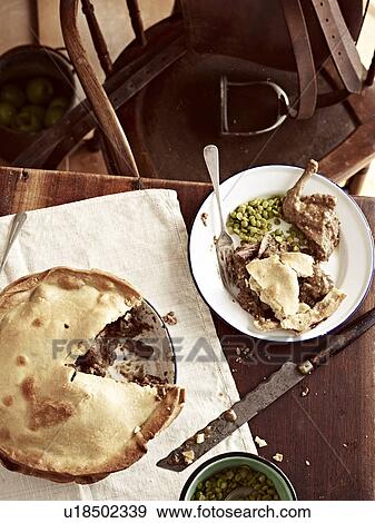 Rustic table with meal of raised pigeon pie View Large Photo Image Stock Photo - Rustic table with meal of raised pigeon pie. Fotosearch
