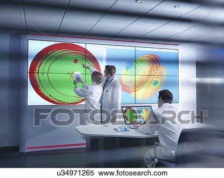 Scientists in meeting in front of graphical display of silicon wafer on screens View Large Photo Image Stock Photography - Scientists in meeting in front of graphical display of silicon wafer on screens. Fotosearch
