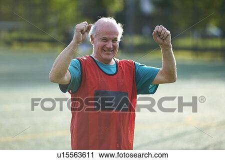 Senior man wearing sports bib cheering View Large Photo Image Stock Image - Senior man wearing sports bib cheering. Fotosearch