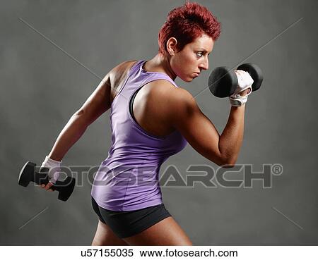 Side view studio portrait of young woman poised with dumbbells View Large Photo Image Stock Photography - Side view studio portrait of young woman poised with dumbbells. Fotosearch