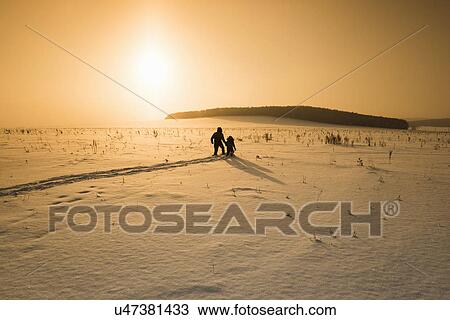 "Silhouetted man and son walking in snow covered landscape at sunset, Sarsy village, Sverdlovsk Oblast, Russia" View Large Photo Image Stock Image - "Silhouetted man and son walking in snow covered landscape at sunset, Sarsy village, Sverdlovsk Oblast, Russia". Fotosearch