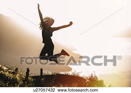"Silhouetted view of young woman jumping mid air at sunset above Lake Atitlan, Guatemala" View Large Photo Image Stock Image - "Silhouetted view of young woman jumping mid air at sunset above Lake Atitlan, Guatemala". Fotosearch