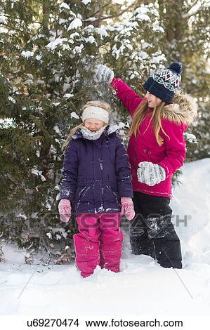 Picture - Sisters playing outside in the snow. Fotosearch