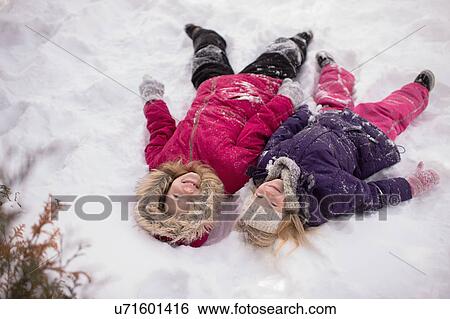 Sisters playing outside in the snow View Large Photo Image Stock Photograph - Sisters playing outside in the snow. Fotosearch