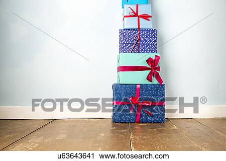 Stack of five wrapped christmas gifts on wooden floor View Large Photo Image Stock Image - Stack of five wrapped christmas gifts on wooden floor. Fotosearch