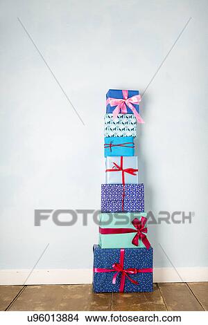 Stack of six wrapped christmas gifts on wooden floor View Large Photo Image Picture - Stack of six wrapped christmas gifts on wooden floor. Fotosearch