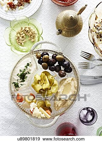 Still life dish of pickled vegetables and chillies with hummus View Large Photo Image Stock Photo - Still life dish of pickled vegetables and chillies with hummus. Fotosearch