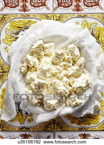Stock Image - Still life of homemade Italian ricotta in bowl. Fotosearch